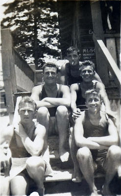 Members of Manly Surf Club sitting on the steps outside the pavillion. Seated front left is Ken J Broughton, Hon. Treasurer