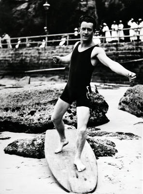 Young man posing on a surfboard on Fairy Bower