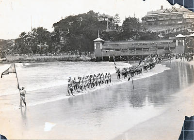 Southern end of Manly Beach during a surf carnival with a march past in progress