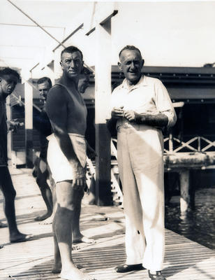 Group portrait of Tom O'Neil, Manager of Manager Baths and Joe Morgan of Manly Amateur Swimming Club at Manly Baths. In the background are Bill Fury and Bill Henderson