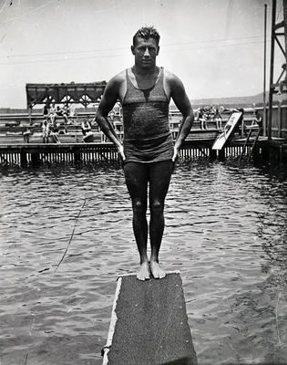 Dick Eve standing backwards on a diving board at Manly Baths