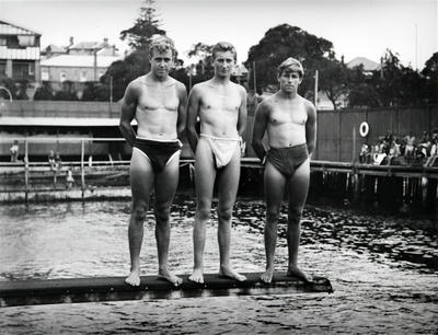 Young men standing on the diving board at Manly Baths