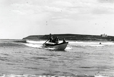 Surfboat riding a wave