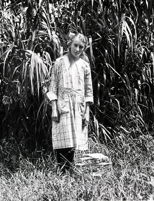 Young girl with a caged galah