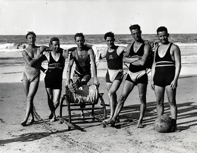 Lfesavers(group) beside a surf reel on Manly Beach