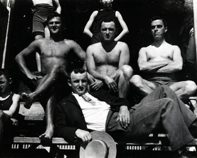 Group portrait of five young men at at unknown location, but possibly at Manly Baths