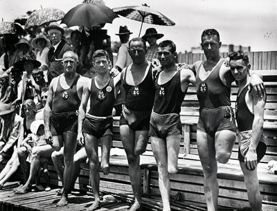 Group portrait of six one-legged members of Manly Amateur Swimming Club at Manly Baths. The men are probably returned servicemen.