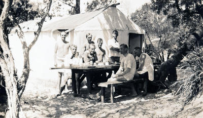 8 young men at one of the camps at Freshwater Beach. Clive Bell seated at left