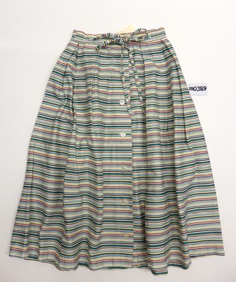 Cotton skirt with thin black, pink, green, yellow and white horizontal stripe, buttons down the front. Machine sewn, eight pleats off waistband