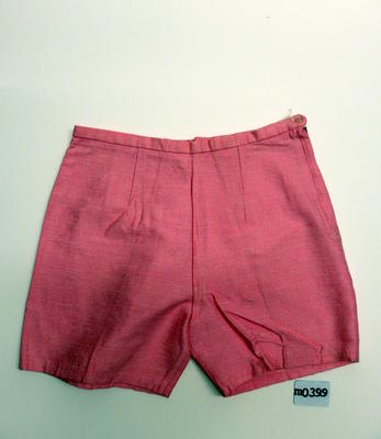 Pink nylon and viscose shorts, two front and four back darts, waist band, zipper and button front LHS. Machine sewn