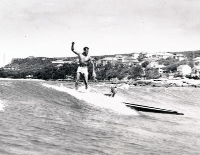 Ray Leighton sufing with woman off Fairy Bower.