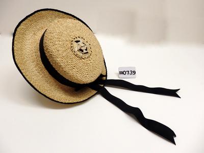 Sunhat cabbage tree palm leaves cotton ribbon straw colour black coiled plait stitched flat and top crown black ribbon around crown long tailed bow at back short brim ribbon edging on rim