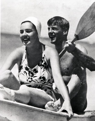 Couple in swimwear in surf canoe.