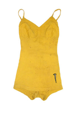 Yellow woolen one piece with shaped bustline, V back and cross-over straps. Modesty skirt with black Lance Sword logo on left side.