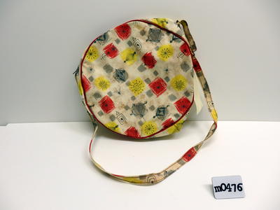 Textured vinyl yellow red grey squares and abstract grey stars diamond rectangle designs red piping circular and shoulder strap and adjustable length buckle zipper over top machine sewn