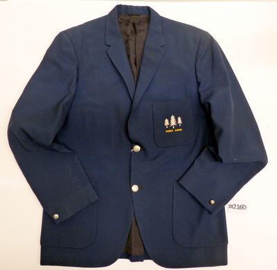 Navy blue blazer with silver buttons at front and cuffs, 3 patch pockets with Norfolk Pines & Manly Band embroided on them