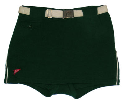 Woollen, green, skirt front with white piping down outside legs. Small pocket (tab and button) white belt - herringbone pattern cloth, and silver interlocking buckle. machine sewn. "Speedo", size 40