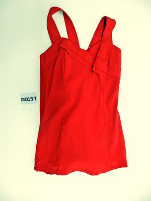 Rayon/rubber red two pleats over top right bust diagonally across to lower left bust elasticised back bottom legs straps crossover high back button to costume