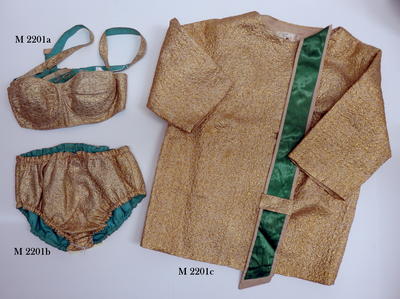 Three piece matching outfit. Gold lame bikini with matching beach coat. All three items are lined with green cotton. Bra has underwire cups with buttoned straps. Pants are bloomer style with gathered elastic legs and waist. Coat has three-quarter sleeve