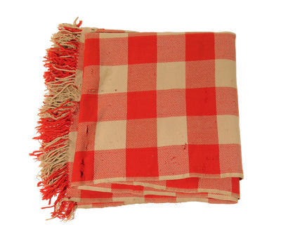 Woollen blanket in red and fawn check tassels on two sides. Embroidered name 'M Radford' in corner