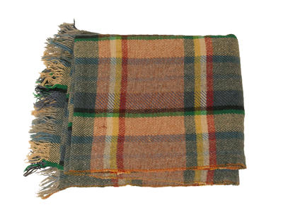 Heavy wool blanket in dull multicoloured tartan tassels on two ends