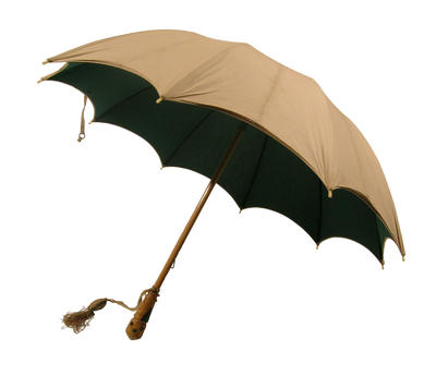 Parasol with wooden central rod, cotton canopy of cream outer and green inner, metal frame, rope with tassel from handle decorated in green V's and spots. British make