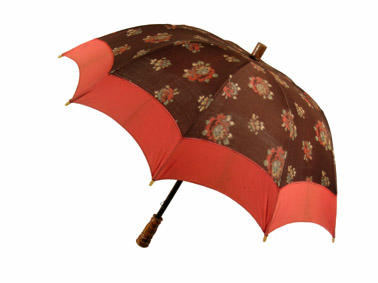 Parasol with wooden central rod brown canopy with flowers and red band metal frame handle engraved with lines and dots steep dome shape British make