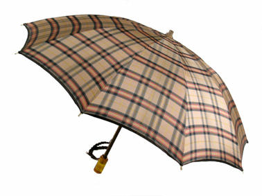 Parasol with wooden central rod nylon tartan canopy green red and brown on pink metal frame yellow plastic handle with brown rope flat shape