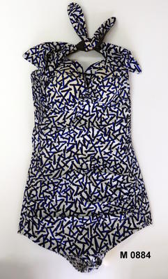 Cotton blue black and white matchstick print, black lined ties across padded bodice, shirred backm curved modesty skirt.