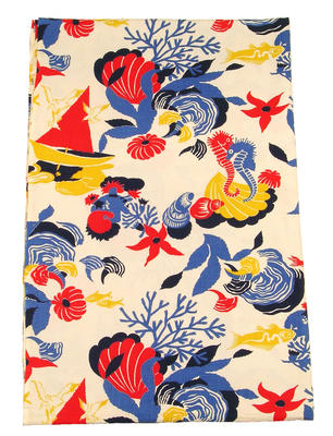 Length of cotton printed material white background with seashells, fish and boat pattern in blue yellow and red