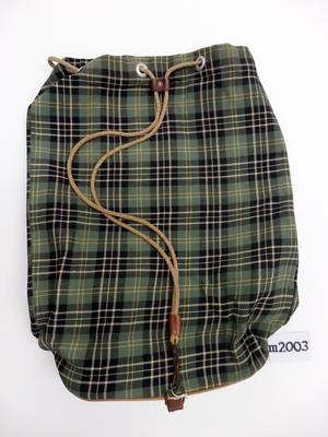 Canvas bag, green tartan print with plastic piping around the base, rope drawstring with leather fastener, machine sewn