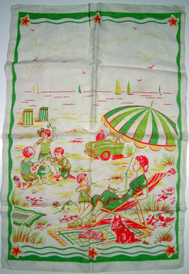 White cotton with lime green, yellow, red print of family beach scene. Bordered with flowers at top & bottom