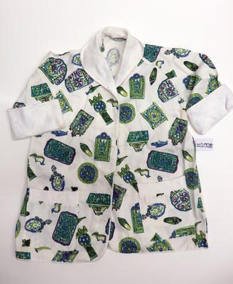 Printed white cotton w/ terry towelling trim green, blue & purple coloured motifs. Short sleeved cuffed left & right hand pockets. No buttons.