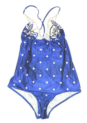 Polyester lycra one piece in royal blue and white. White dot print on bodice and white flower print on chest. Two neck straps that button at back with two buttons