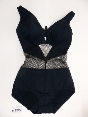 Black one piece with black net midriff and black tie at bust