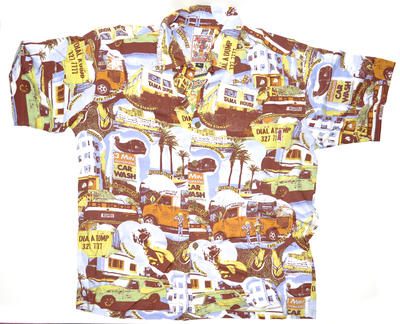 Short sleeved man's Hawaiian shirt in printed rayon with collar. Front fastening with 6 coconut shell buttons, patch pocket left breast, machine sewn. Print features images of Sydney beach locations with names: Tam.. (More details: see objects worksheets)