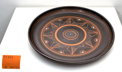 small black bowl with terracotta carved design