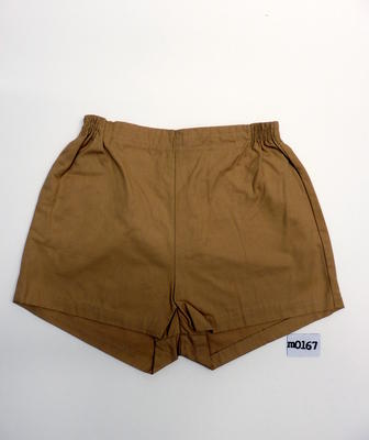 Cotton, mustard coloured trunks with zippered back, elastic sides, one pocket RHS, size 30. Machine made