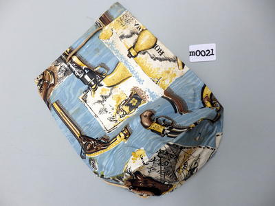 Vinyl beach bag patterned with pistols coins and maps on a watery background in blue yellow brown black white drawstring tied machine sewn