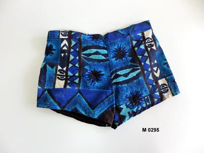 Boys Trunks blue Pacific abstract design on front and black stretch back with white cording down side seams fully separate lining in white nylon elastic waistband at back and cord at side coin pocket RH front machine made S34