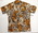 Short sleeve shirt. Cotton, brown buttons, brown orange, white, black hibiscus/floral motif