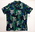 Short sleeve shirt. Cotton. Two pockets, buttons down front. Blue, green, white, turquoise tribal motifs